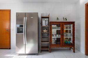 尼泰罗伊Casa incrível com 04 suítes - 5 min de Itacoatiara的厨房配有不锈钢冰箱和橱柜