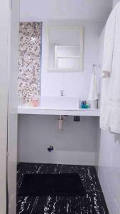 特鲁希略Moderno y nuevo departamento “Casa Blanca”的白色的浴室设有水槽和镜子