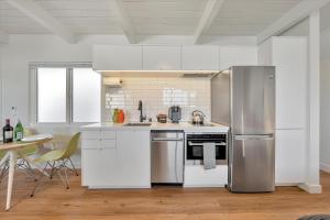 圣卡洛斯Silicon Valley Stay Apartments的厨房配有白色橱柜和不锈钢冰箱