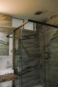 卡哈马卡Redwalls Lodge的浴室里设有玻璃门淋浴