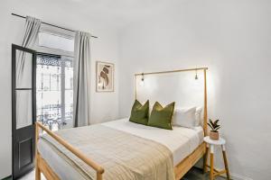 悉尼Surry Hills l 2 Bedroom Terrace Home的一间卧室配有一张带绿色枕头的床