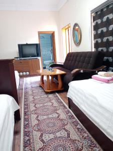 布哈拉Hotel Nasriddin Navruz的客厅配有沙发和桌子