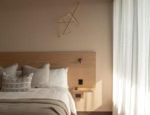 拜伦湾Hotel Marvell Byron Bay的一间卧室配有一张大床和木制床头板