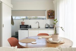 哈士汀Magnolia Studio的厨房配有木桌、椅子和水槽