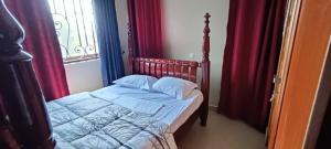 Gulucosy living的卧室内的一张床位,配有红色窗帘