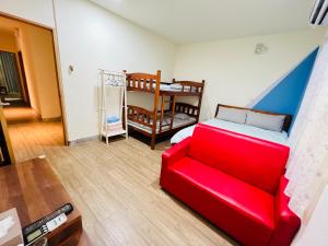 Xingang新港平安民宿的客厅配有红色的沙发和床。