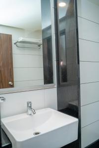 浦那Hotel Dreamland的浴室设有白色水槽和镜子