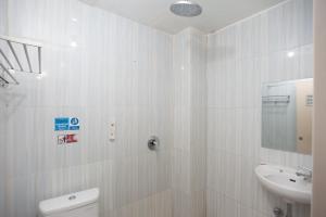 班达楠榜AVA Guesthouse Mitra RedDoorz Lampung的白色的浴室设有水槽和卫生间。