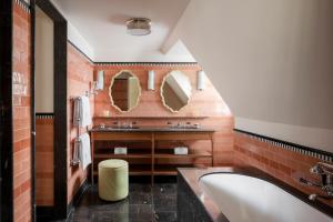 巴黎Le Grand Mazarin的一间带水槽和两面镜子的浴室