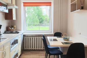 约尼什基斯Studio apartment in Joniškis的厨房配有桌椅和窗户。