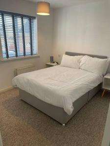 Redhill5 Holborn Spacious Home的卧室配有一张带白色床单和枕头的大床。