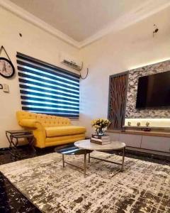 MakurduPeniel Place的客厅配有黄色的沙发和桌子