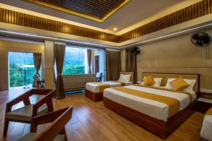 库塔兰Zamin Resort的酒店客房配有两张床和一张书桌