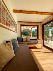 Puerto DunnHuella Patagonia Lodge的带沙发和大窗户的客厅