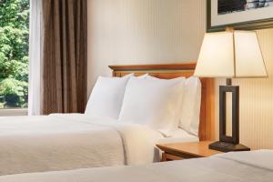 北温哥华Holiday Inn & Suites North Vancouver, an IHG Hotel的酒店客房,设有两张床和一盏灯