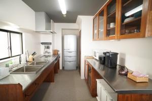 神户塔壁宇阿布瑞格公寓的厨房配有水槽和冰箱