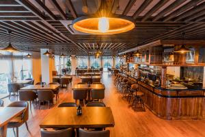 西哈努克Sea Breeze Hotel & Villa的一间带桌椅的餐厅和一间酒吧