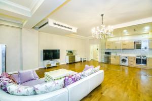 巴库Special VIP Mariott Apartment的一间带白色沙发的客厅和一间厨房