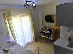 塞萨洛尼基Konstantinos's Luxury Studio的配有床和桌子的房间以及厨房