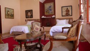 卡萨布兰卡Ryad 91的一间卧室配有两张床和一张桌子及椅子
