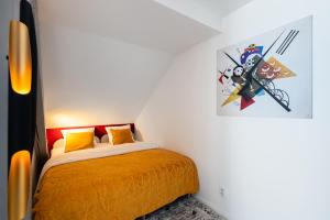 布拉格Luxury 4-rooms apartment with terrace的卧室配有一张床,墙上挂有绘画作品