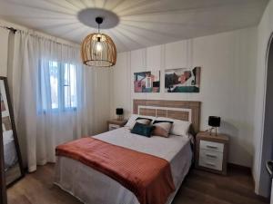 科斯塔卡玛Montes Blancos的一间卧室配有一张大床和一个吊灯。