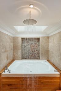 WistonSlebech Park Estate的浴室配有大浴缸及吊灯
