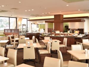 佐世保Sunwest Hotel Sasebo - Vacation STAY 22075v的一间带桌椅的餐厅和一间自助餐厅