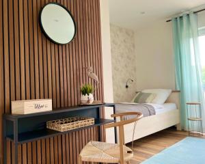 佩特尔斯哈根Große Wohnung Wellness + Sauna + Netflix的一间卧室配有一张床和一张带镜子的书桌