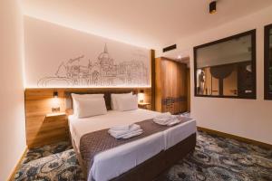 萨拉热窝Hotel Boutique Anoma的酒店客房,配有带毛巾的床
