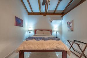 霍普金斯鹦鹉湾度假村的一间卧室配有一张带两盏灯的床。