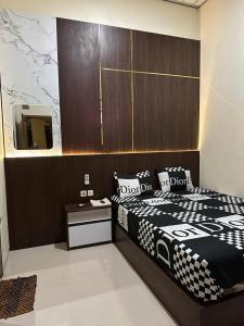 KemiriDavid Guesthouse by XNR的卧室配有黑白床和镜子