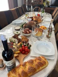 BrebCasa Veche Breb的一张餐桌,里面装满了食物和一瓶葡萄酒