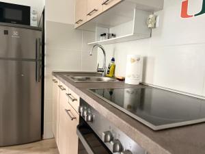 布达佩斯Corvin Promenade Crystal的厨房配有水槽和不锈钢冰箱