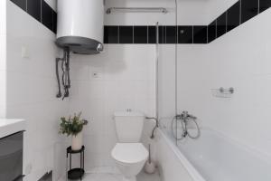 布拉格Attic Apartment in Smíchov by Prague Days的白色的浴室设有卫生间和浴缸。