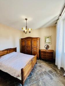 马赛Agréable maison provençale avec jardin的一间卧室配有一张大型木床和吊灯。