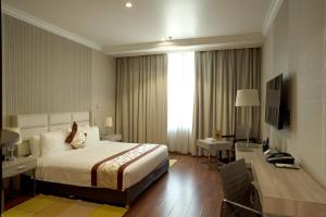 科威特城市之塔酒店的酒店客房配有一张床、一张书桌和一张书桌。