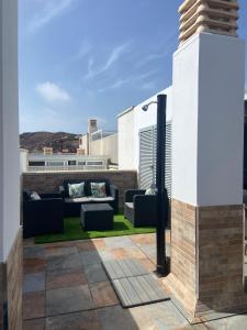加尔达尔Ático Playa Sardina的屋顶上配有沙发的庭院
