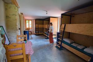 鲁瓦扬地区圣让Hostel Quartier Libre的一位妇女站在带双层床的房间