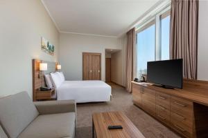 利雅德Hilton Garden Inn Riyadh Financial District的配有一张床和一台平面电视的酒店客房