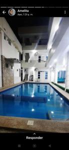 通苏帕Hostería Luz Del Mar的大楼里的一个大型蓝色游泳池