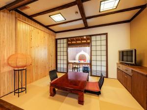 阿苏市AsoTsuruya的客厅配有桌子和电视
