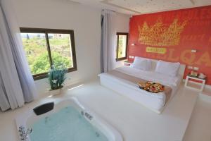 朱拜勒艾礼富精品酒店的酒店客房配有一张床和浴缸。