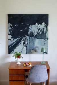 伯尔尼artroom的一张桌子、一把椅子和墙上的绘画