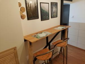 斯雷布纳古拉Przystanek Srebrna Góra的一个带木桌和两张凳子的小厨房