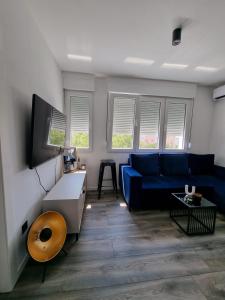 斯普利特LUX BRAND NEW APARTMAN MARIKELA的客厅配有蓝色的沙发和桌子
