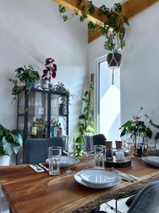 布伦瑞克SKYLINE Penthouse Apartment - Luxus & Zentral的一张长木桌子,上面有盘子和玻璃杯