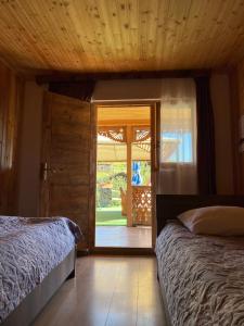 OmaloGuest House Gordila的一间卧室设有两张床和滑动玻璃门