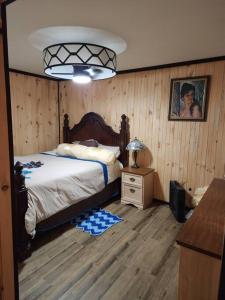 3 bed/2 bath Riverside cabin的一间卧室配有一张床和一张带台灯的桌子