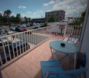 圣胡安Urban Lodgings Two @ Roosevelt 457的一个带桌椅的阳台和一个停车位